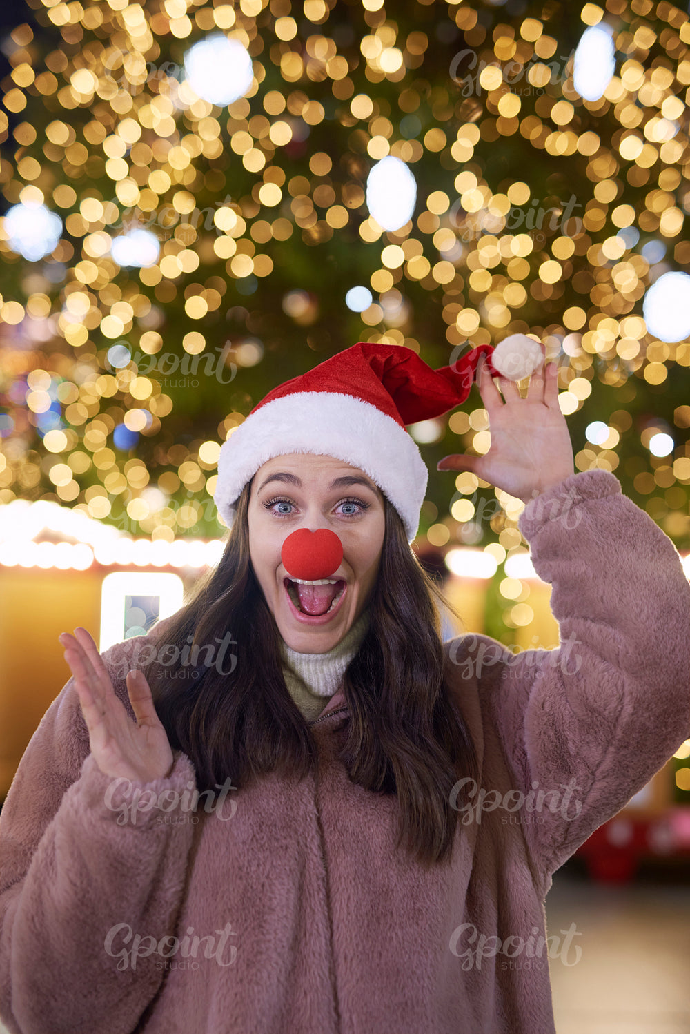 Funny woman with Santa hat and deer nose