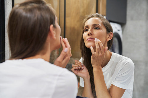 Woman browsing face in the mirror