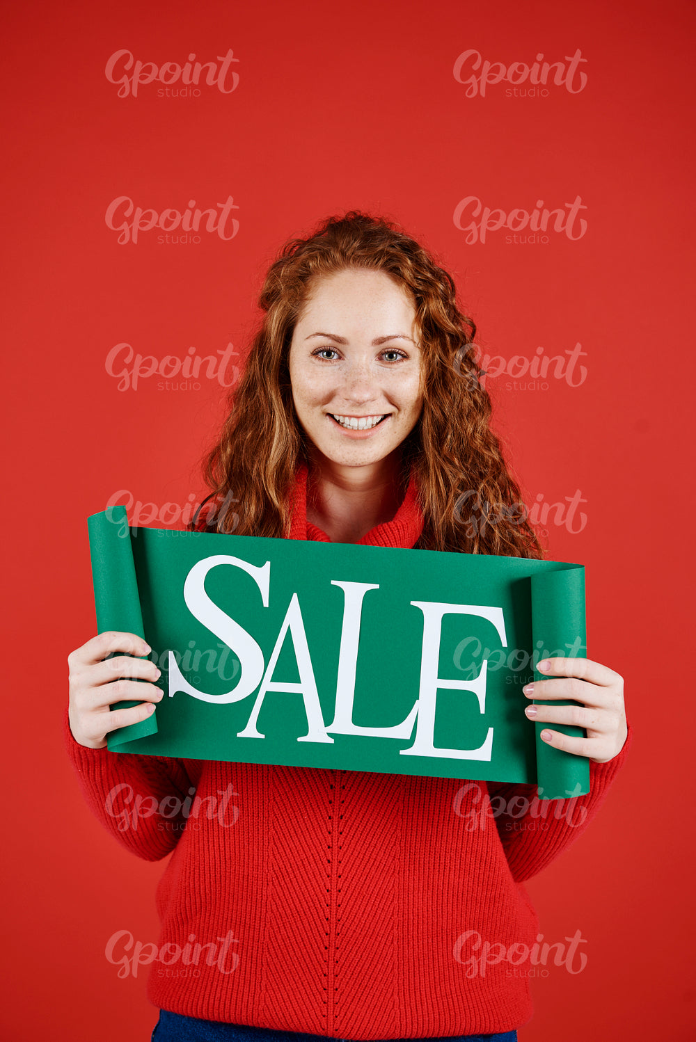 Portrait of girl showing banner of winter sale