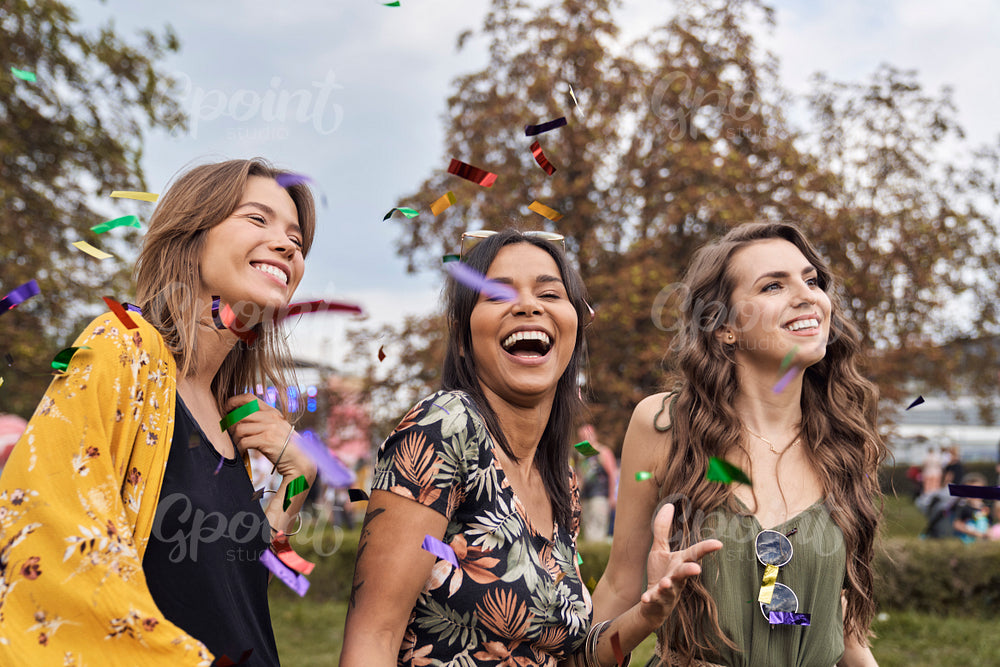 Three friends dancing at the music festival 