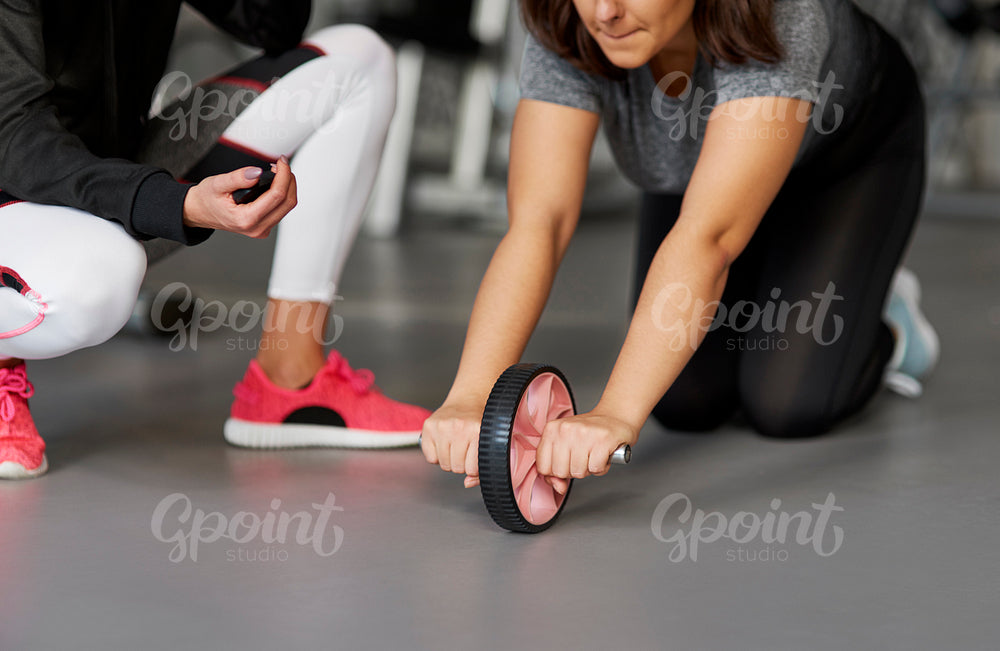 Close up of young woman exercising in the gym