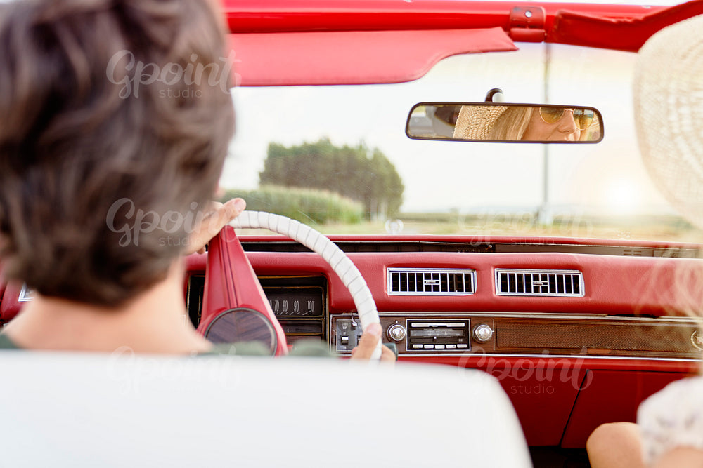 Close up rear view of couple driving car