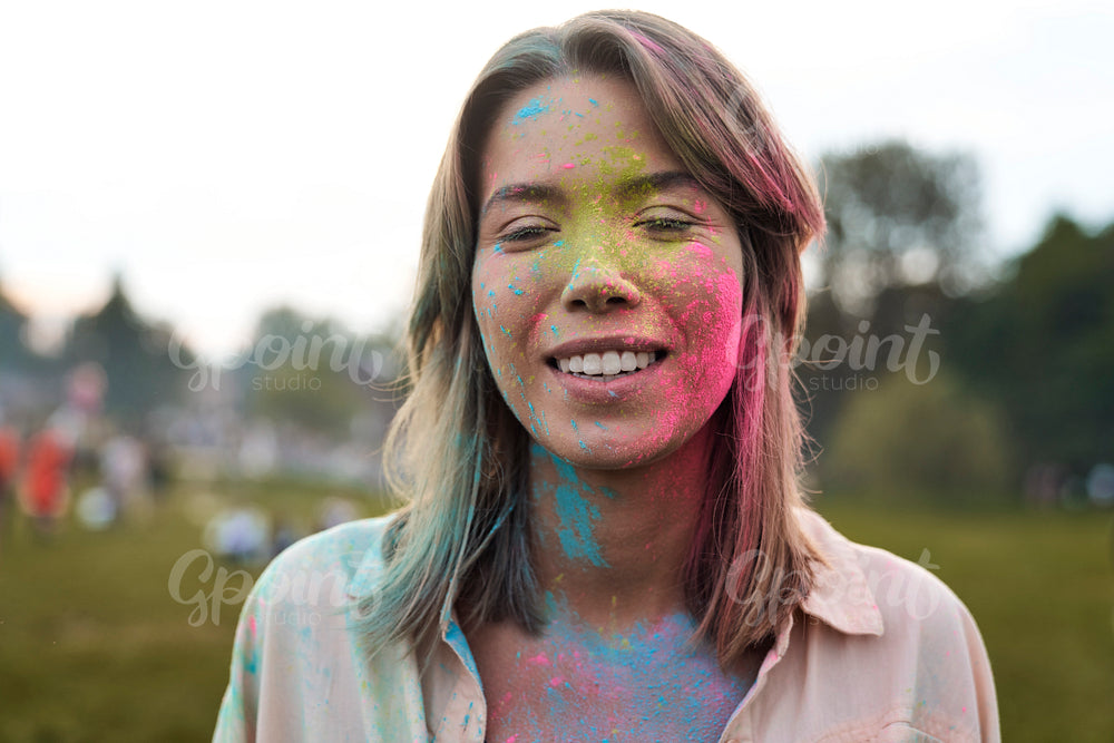 Face of woman with coloured powder at Holi Festival  