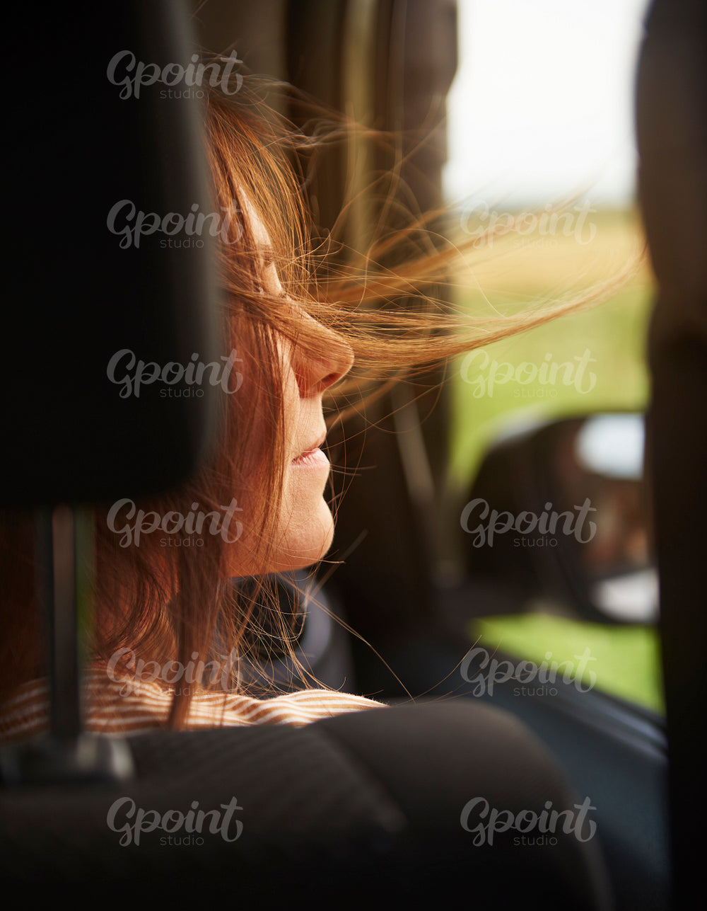 Rear view of woman enjoying the view during road trip