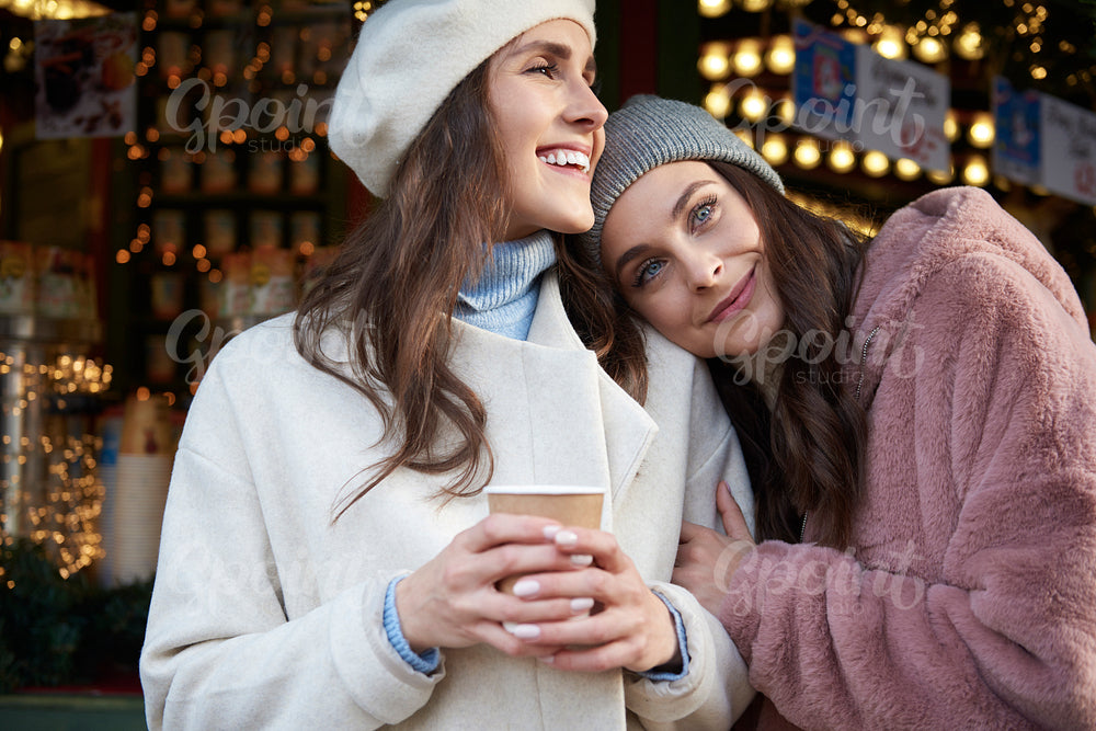Two women hugging on Christmas market
