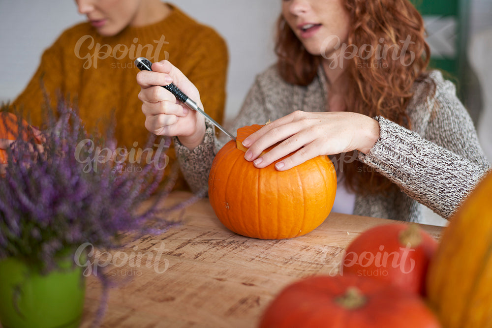 Woman's hands preparing decorations for Halloween