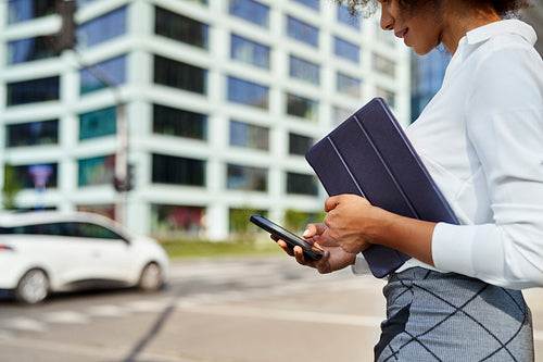 Close up of businesswoman with digital tablet and phone outdoors