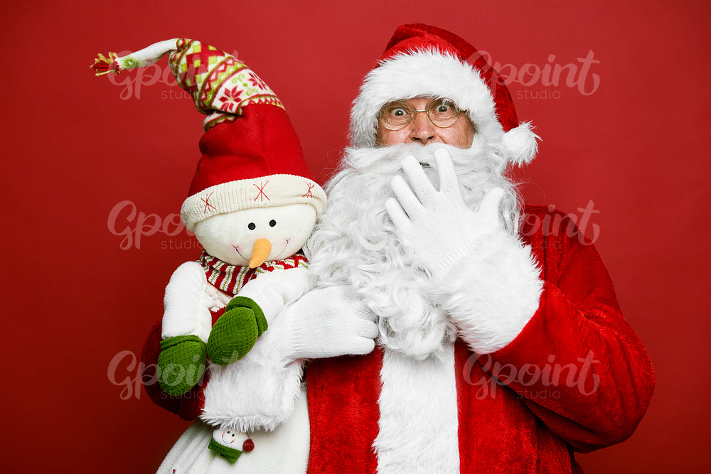 Funny caucasian Santa Claus with cute snowman 
