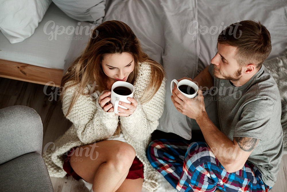 Happy couple talking and drinking coffee