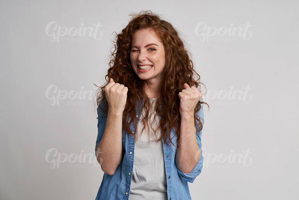 Young woman showing winning sign