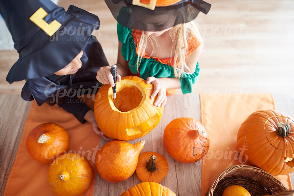 Children carving from the pumpkin