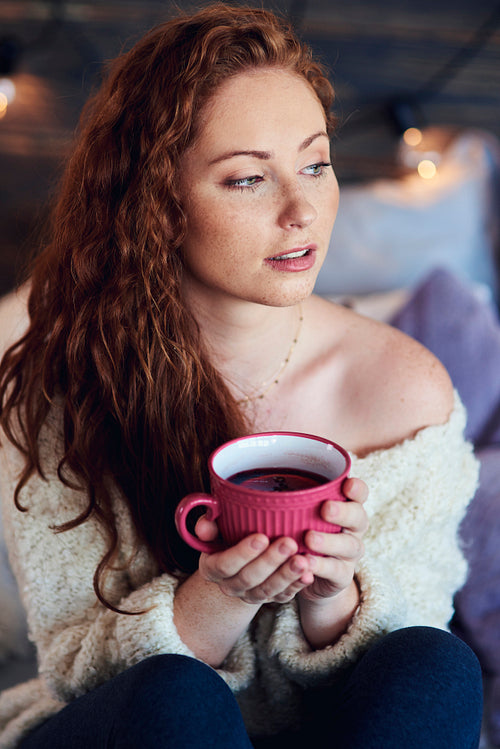 Beautiful woman drinking hot tea in winter day