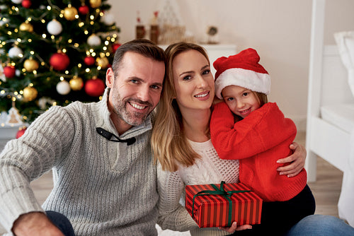 Portrait of smiling family with Christmas gift