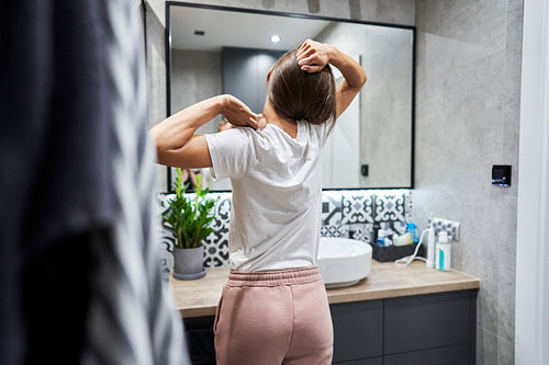 Woman stretching in the bathroom