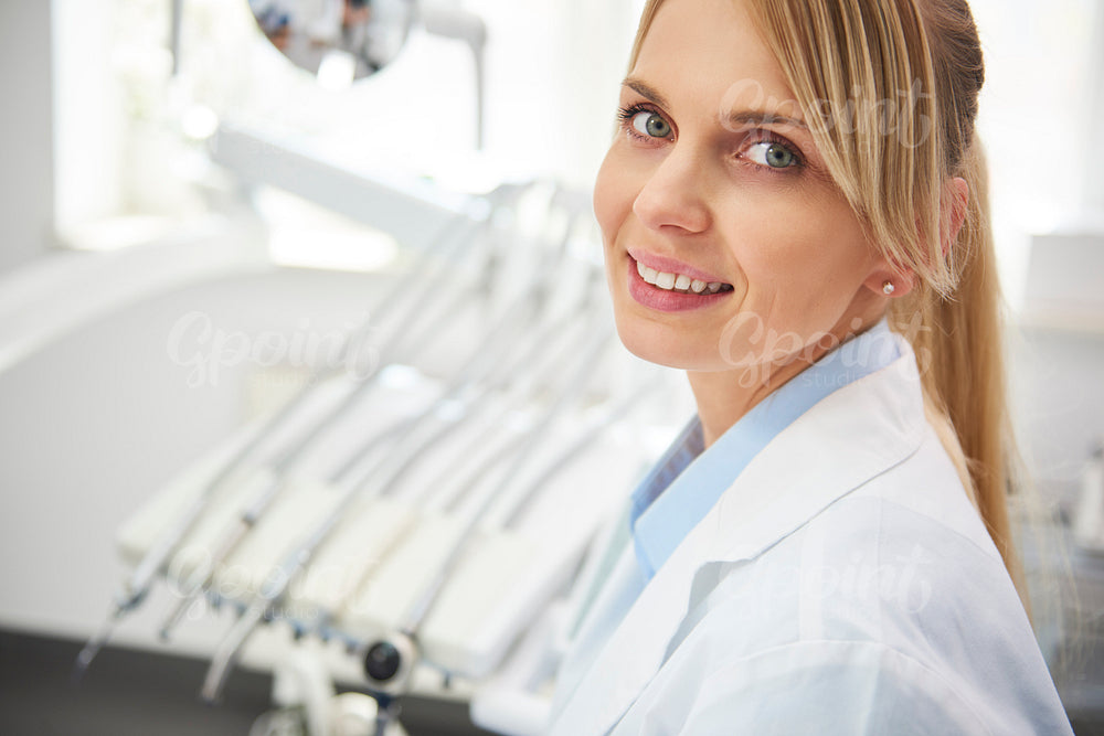 Portrait of smiling female dentist in dentist's office