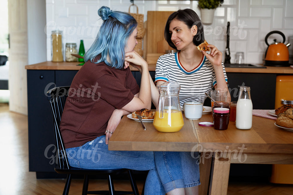 Two woman staring at each other while breakfast