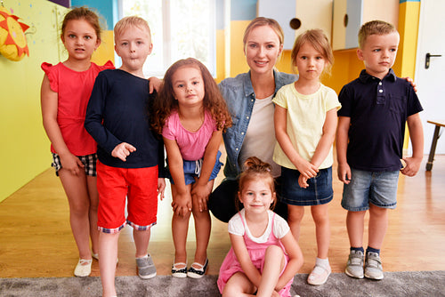 Group of kids and teacher in the preschool