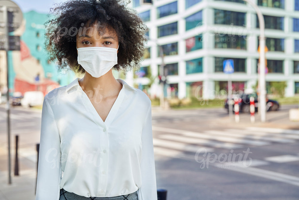 Portrait of African woman in face mask on the street