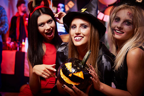 Three women with black pumpkin