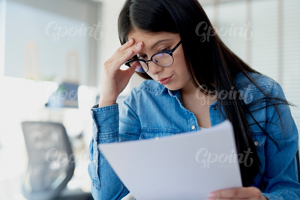 Woman analyzing problem with a document