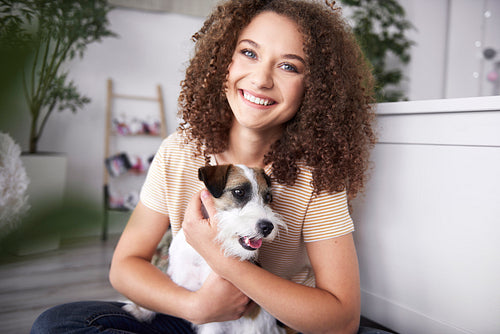 Portrait of smiling teenage girl with her dog
