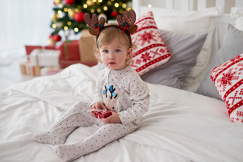 Portrait of charming baby with Christmas gift
