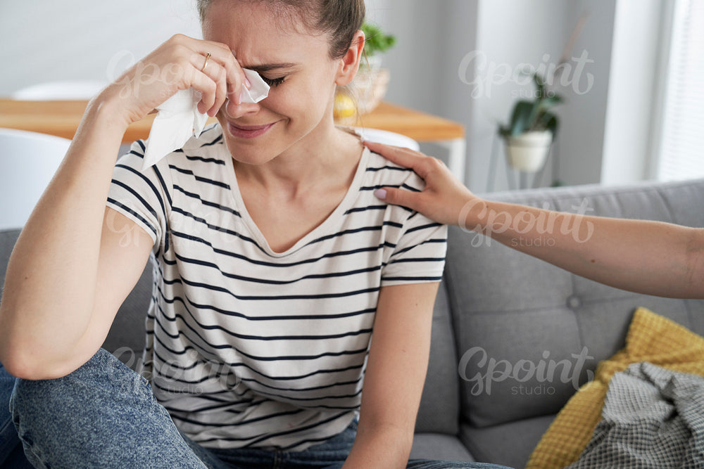 Crying woman and hand cheering her up