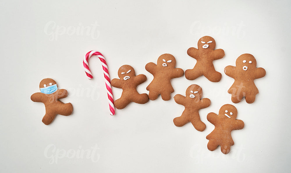 Funny gingerbread man shaped cookies with facial masks