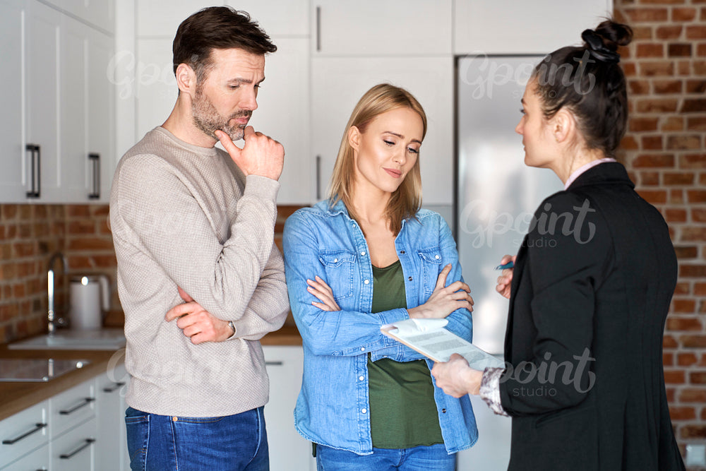 Sad couple during a meeting with a real estate agent