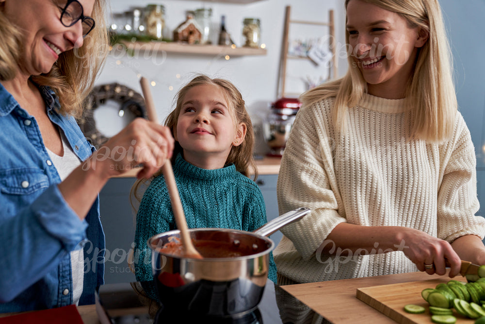 Three generations of women in the kitchen during Christmas time