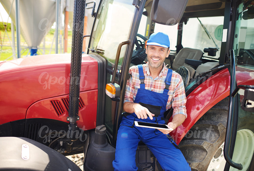 Using digital tablet while sitting in the tractor