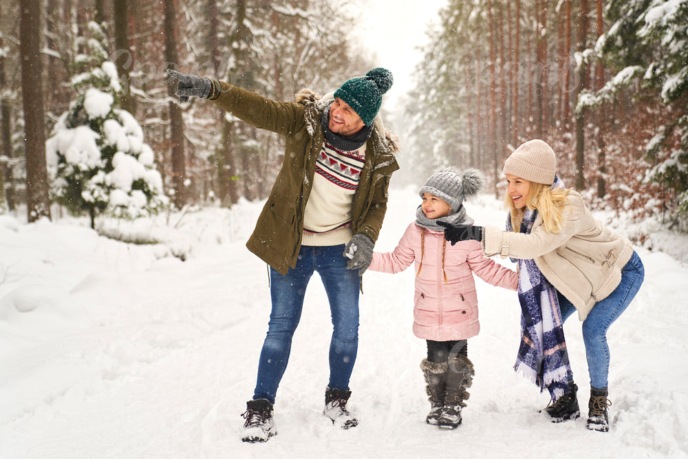 Family spending time in forest during the winter 