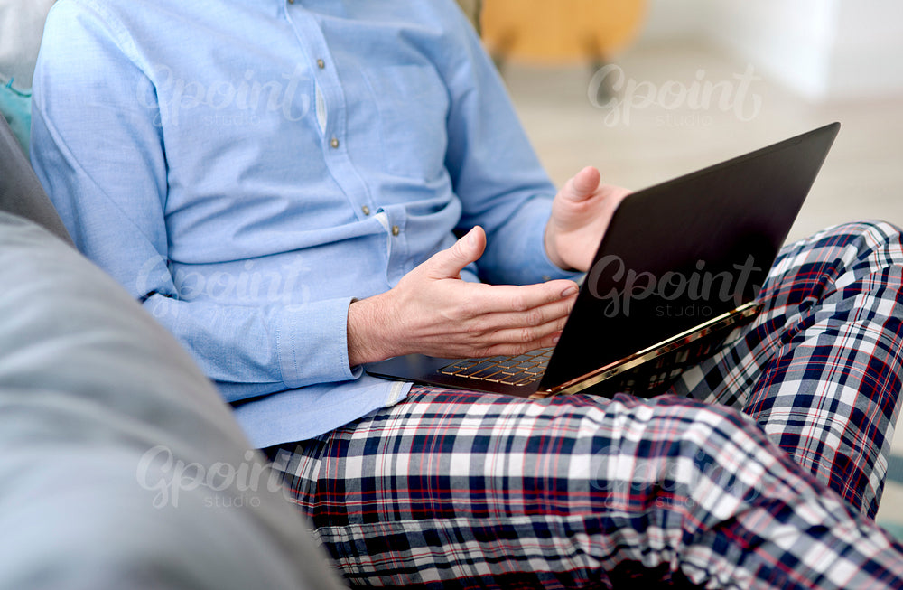 Unrecognizable person working at home on a laptop