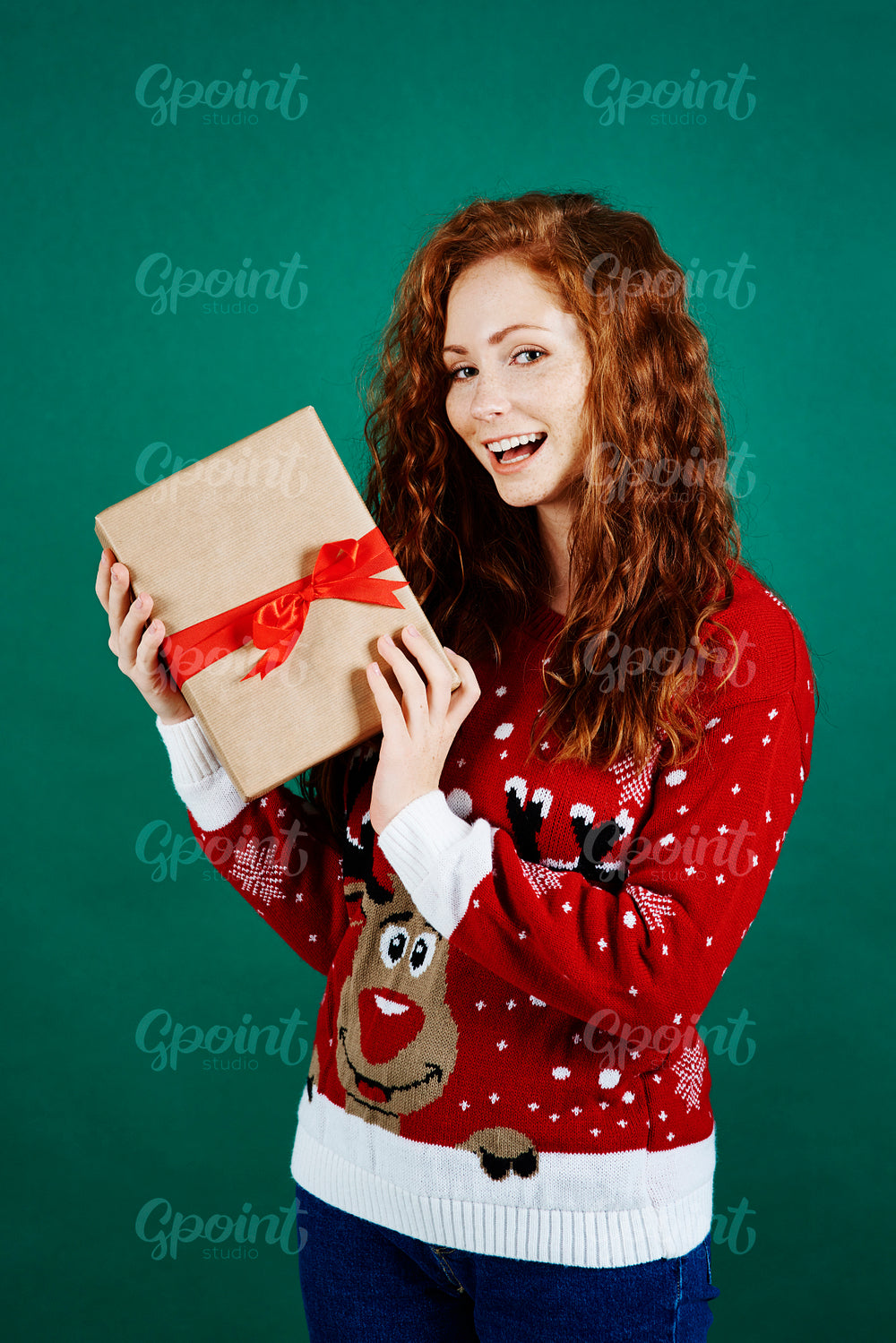Portrait of happy girl holding christmas present