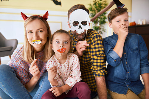 Portrait of happy family spending Halloween together at home