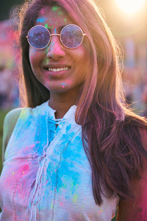 Happy African woman in holi colors at the summer festival