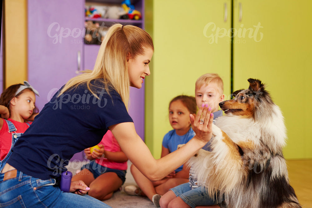 Therapy dog giving woman the paw