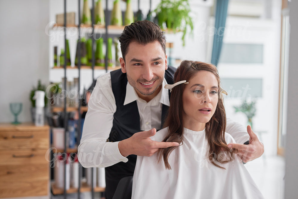 Male hairdresser giving woman good advice
