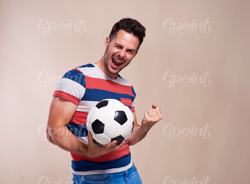 Excited football fan supporting his team