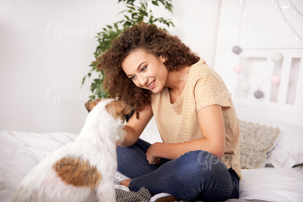 Happy girl and her dog spending time together