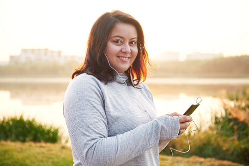 Woman choosing the best song for jogging