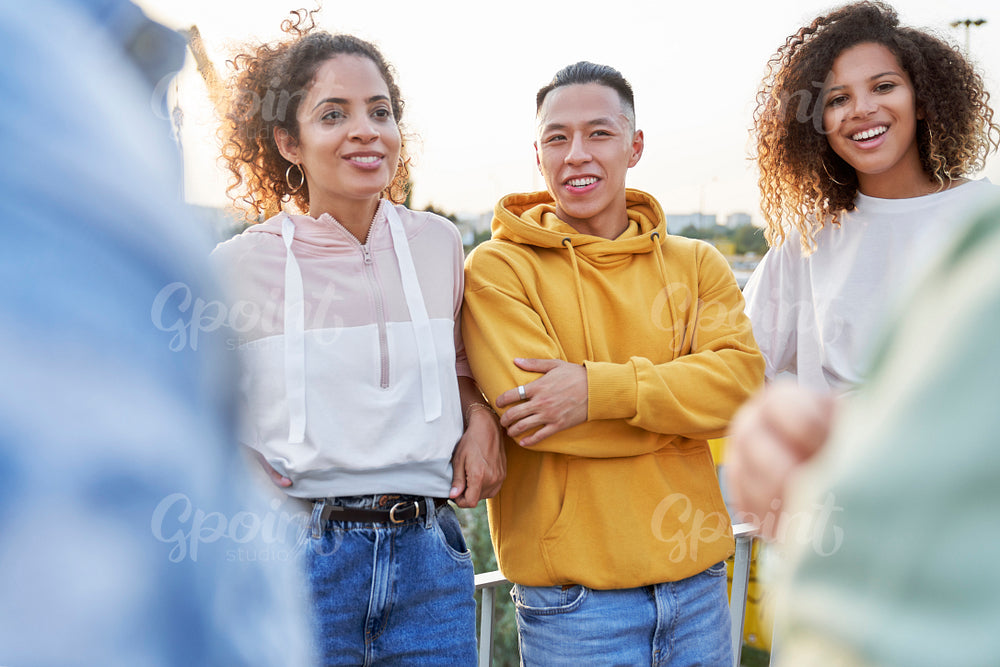 Group of young friends standing and talking outdoors