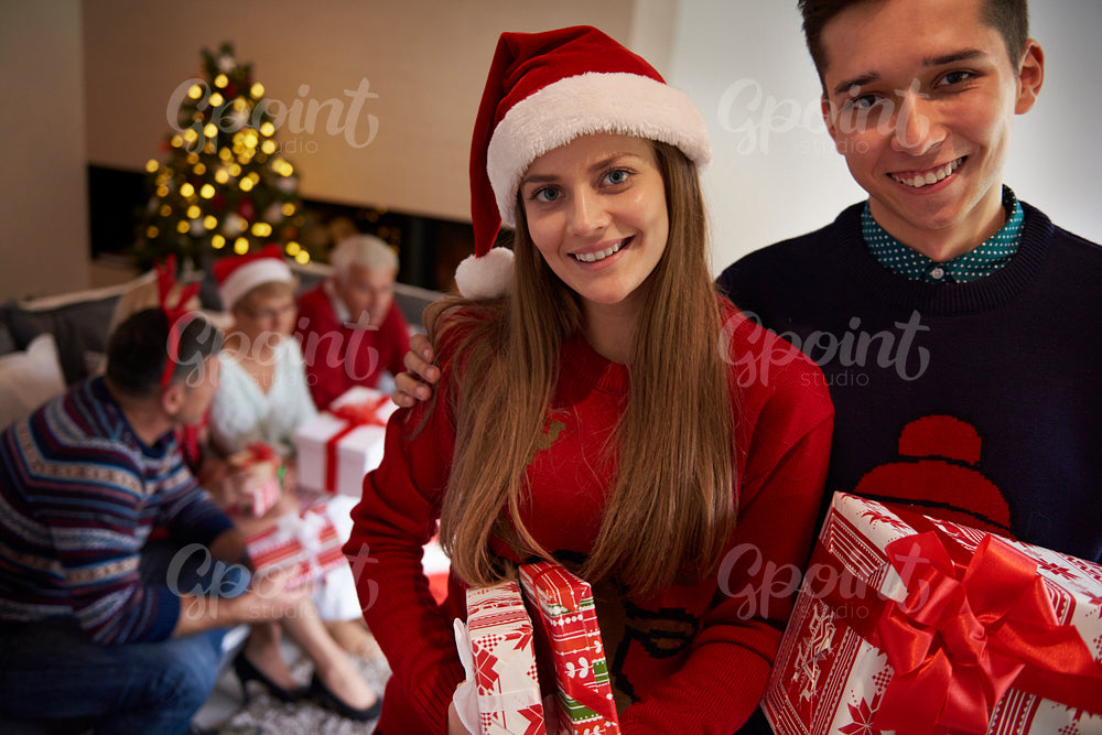 The siblings holding christmas presents