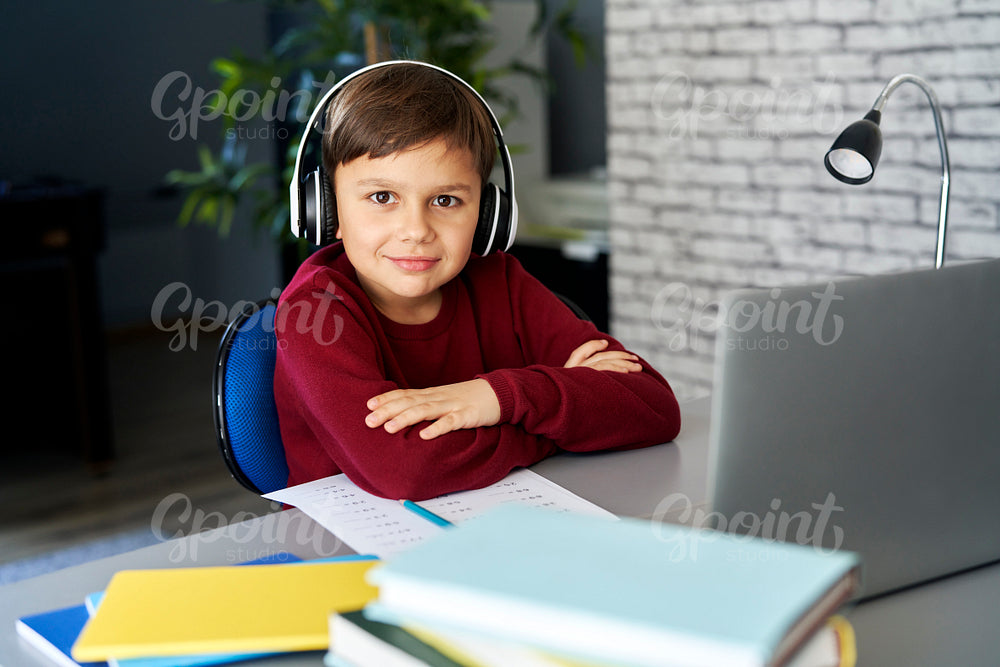 Portrait of smiling boy during while studying at home