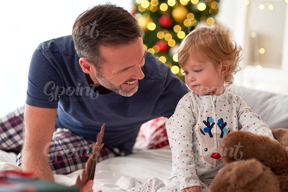 Father and his little daughter spending Christmas morning together