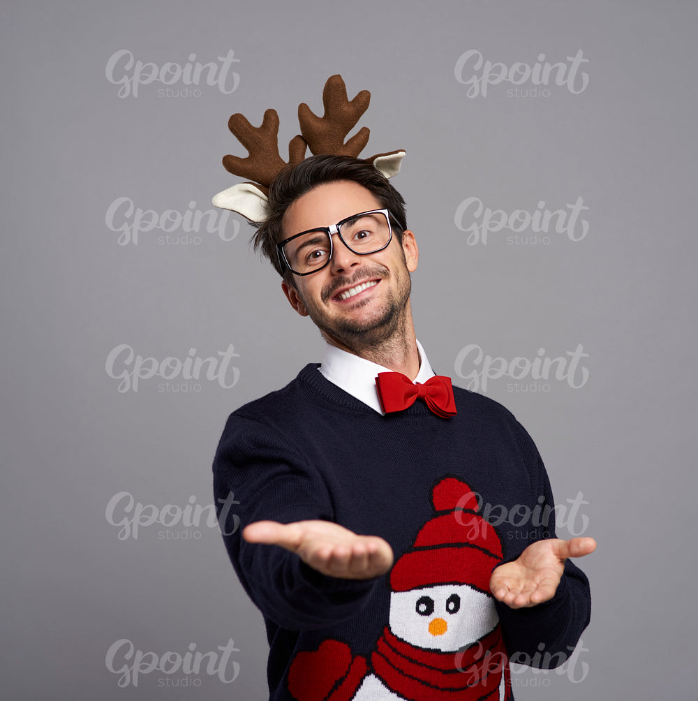 Portrait of man in Christmas clothes with palm of hand