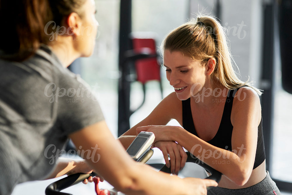 Personal trainer with woman in fitness center