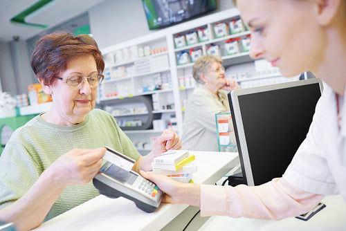 Customer paying by credit card at drug store