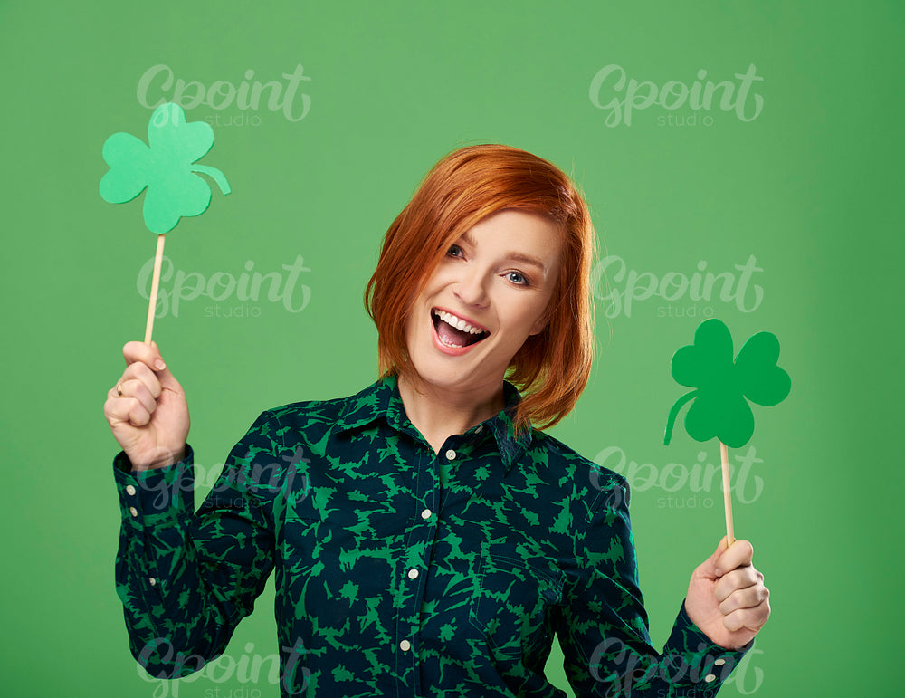 Portrait of screaming woman holding clover shaped banner