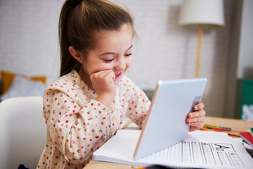 Girl learning with technology at home